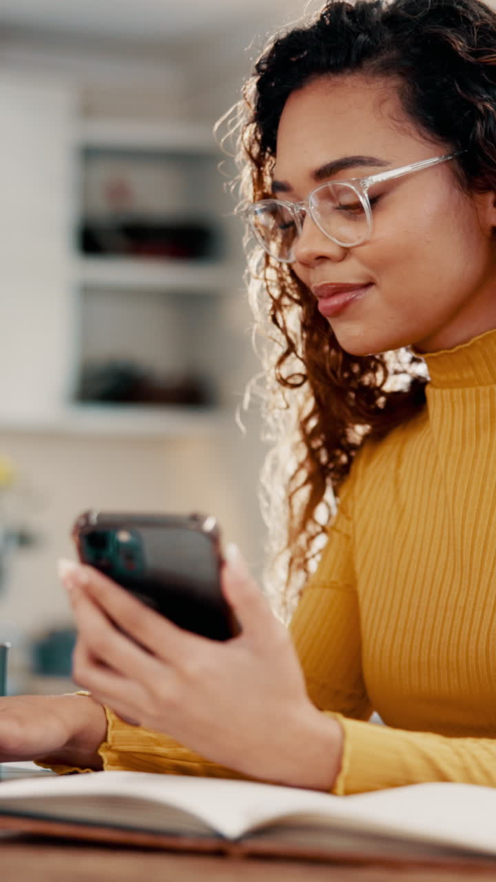 Young Woman in Glasses Using Smartphone While Studying