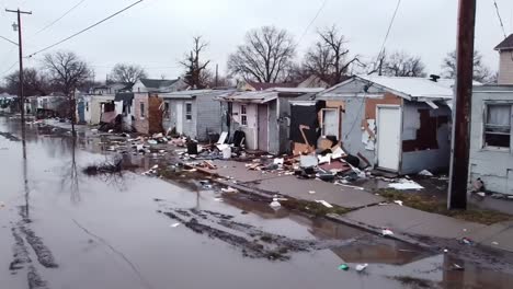 devastating aftermath of a severe flooding event resulting in significant damage to residential structures and surrounding areas, highlighting the need for community recovery efforts