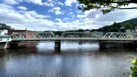 Families-walk-across-rail-bridge-in-Shelburne-Falls-Massachusetts-on-beautiful-summer-day