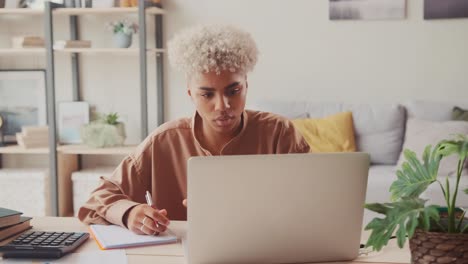 young african woman with many debts feeling stressed calculating finances