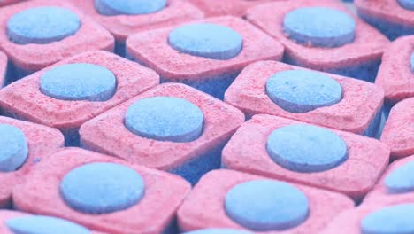 capsules of bluered color for washing dishes in an automatic machine vertical video
