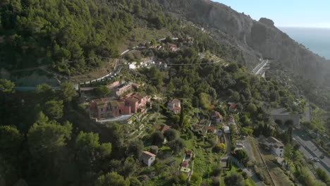 Menton-hillside-villas-on-French-Riviera-overlooking-Mediterranean-coast,-aerial