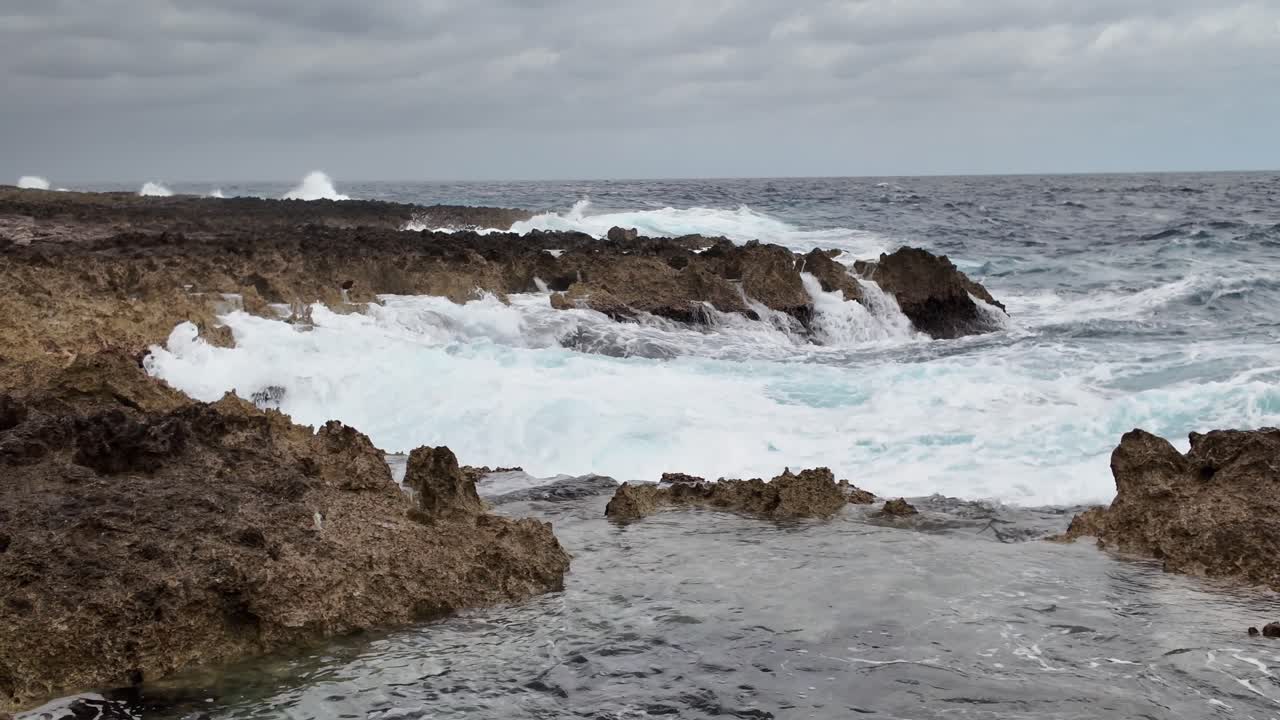 Onde profonde di acqua marina si infrangono sulle rocce