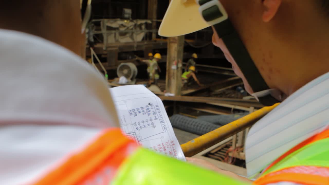Civil Engineers Discussing Project Plan At Construction Site. close up