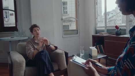 female patient discussing results of therapy with psychologist