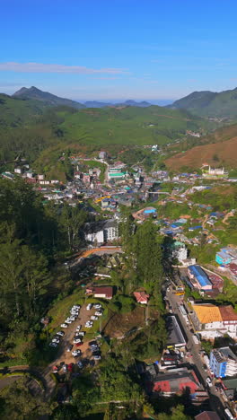 vertical drone shot overlooking the munnar town, sunrise in kerala, india
