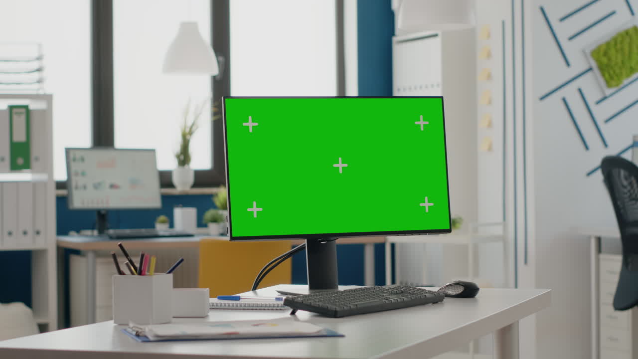 Empty office with green screen on computer display