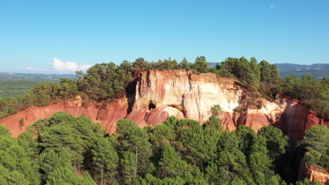 amazing canyon red cliffs in a forest ochre roussillon aerial view sunny day