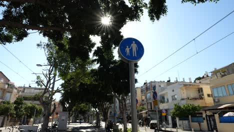 blue signage warning road users of impending pedestrian path