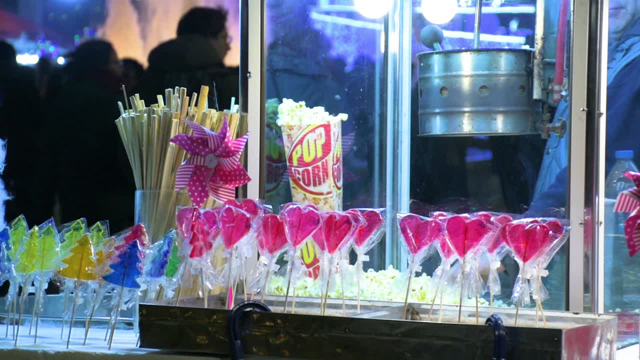dulces coloridos, palomitas de maíz, caramelos y piruletas en la feria de navidad