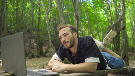 Young-man-video-chatting-in-the-forest.