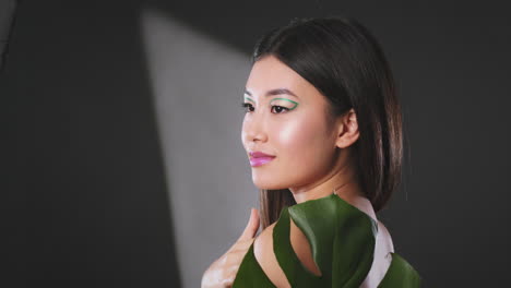 fashion portrait with creative makeup and plant