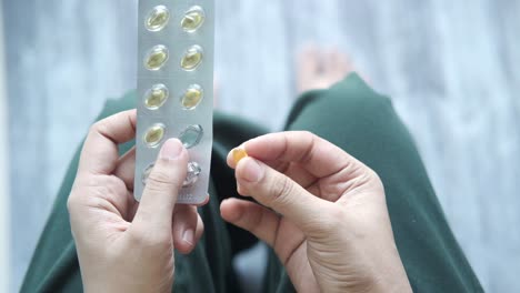 person holding a blister pack of pills