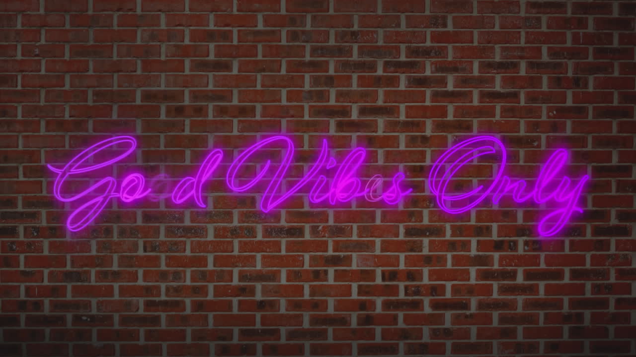 Animation of the words good vibes only in pink flashing neon letters on brick wall