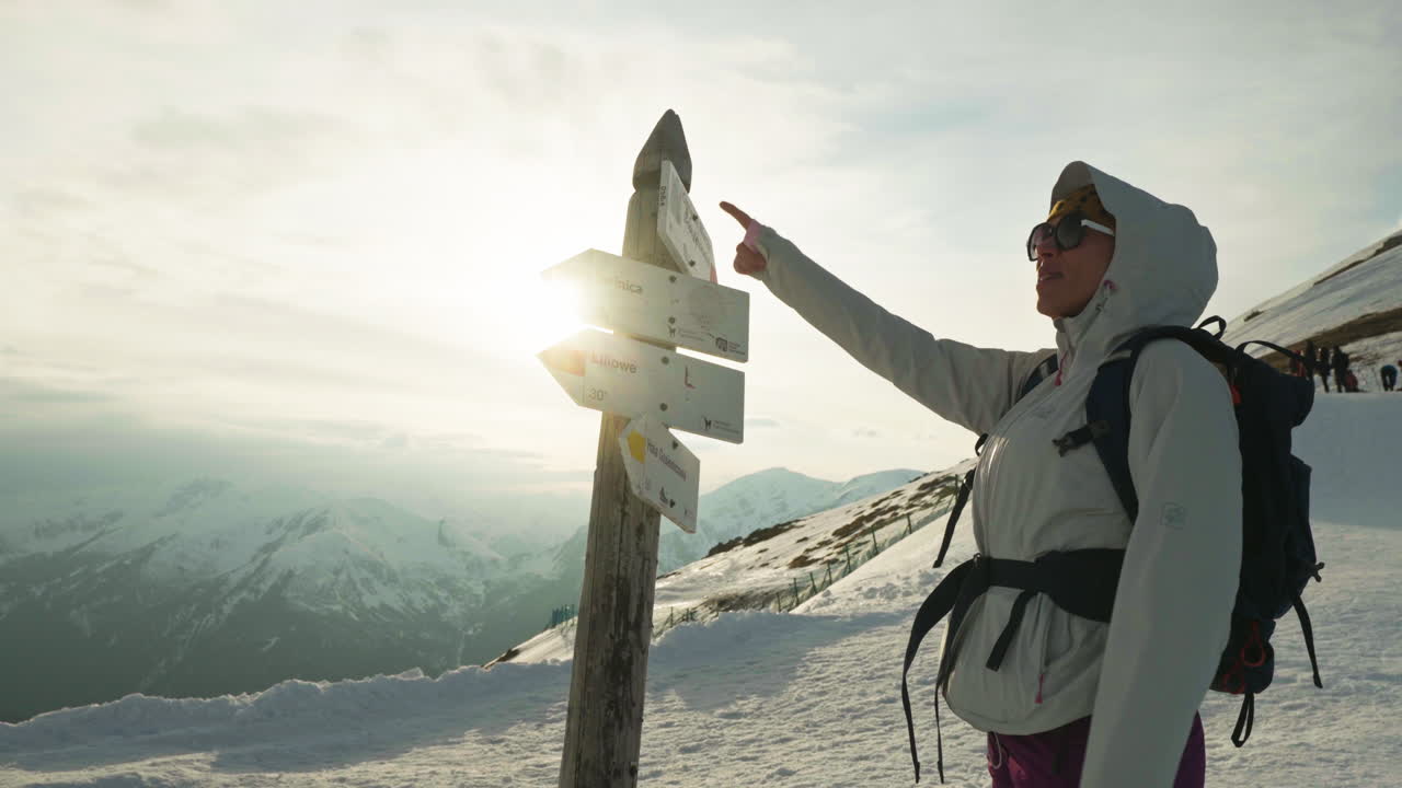 Hiker Looking For Direction On Wooden Sign Board At Tatra Mountains. - medium shot