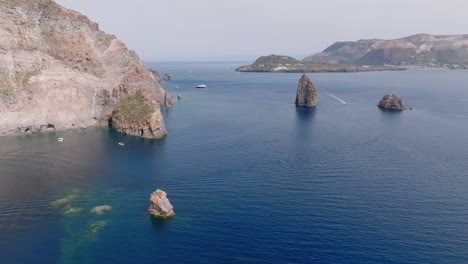 scenic coastal landscape with sea stacks and boats