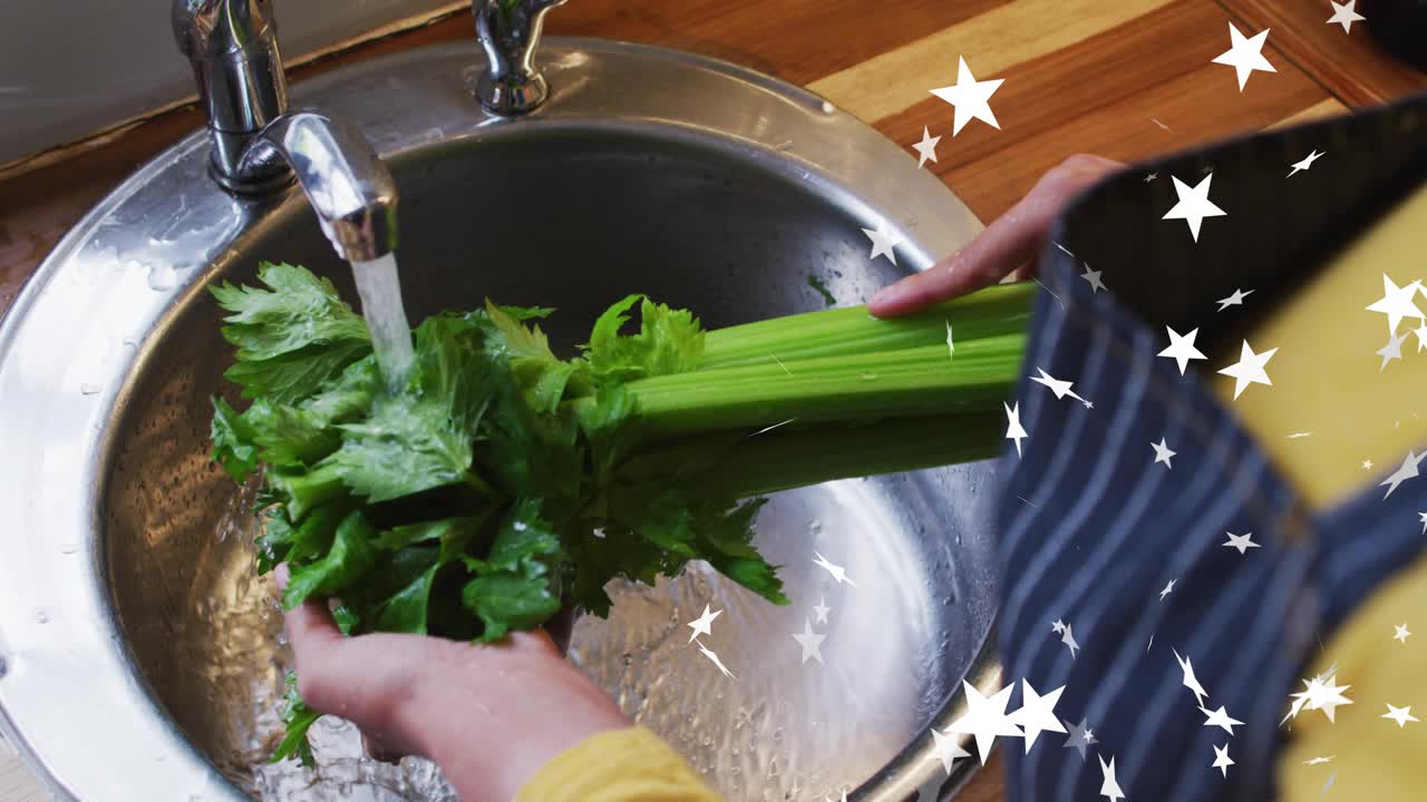 Home cook turning celery under running faucet in kitchen, rinsing debris with star graphics