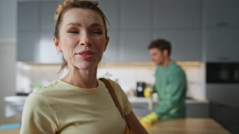 happy woman cleaning house closeup. housewife touching hair enjoying housework