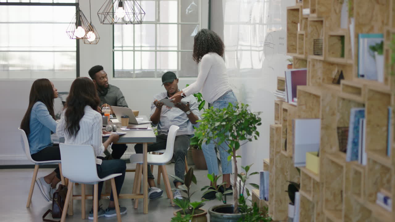 african american business people meeting in boardroom pregnant team leader woman presenting financial graph data showing colleagues information on whiteboard training students in office lecture