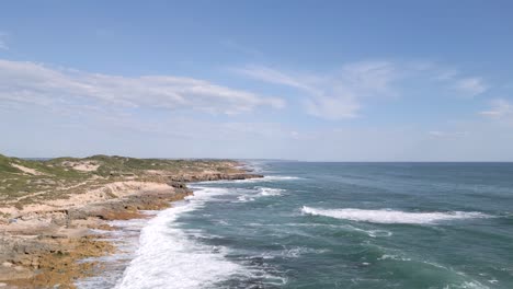 rocky shore and waves crashing along the ocean coast