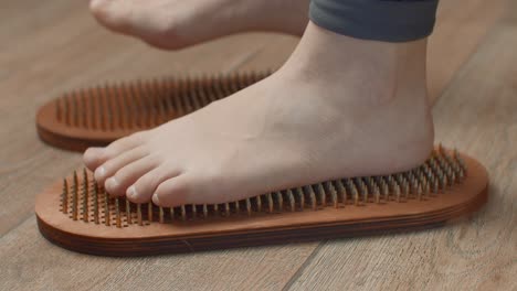 feet on acu-press mats for reflexology and massage