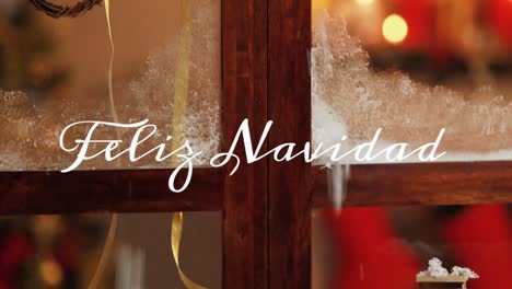 feliz navidad escrito sobre la ventana con decoraciones