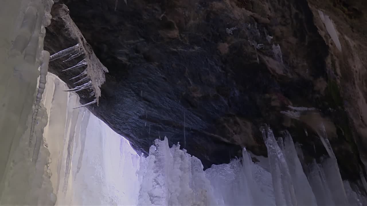 Ice Cave Melting Icicles In Eben Ice Caves, Michigan, USA - Low Angle Shot