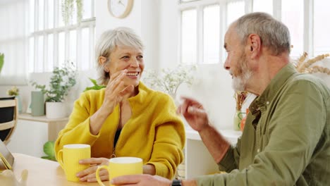 elderly couple enjoying coffee and conversation at home