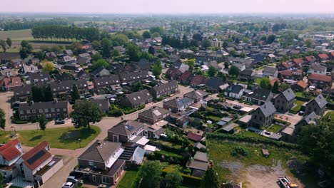 Aerial-footage-of-Budel-residential-area,-showcasing-neat-rows-of-houses,-tree-lined-streets,-and-well-maintained-gardens