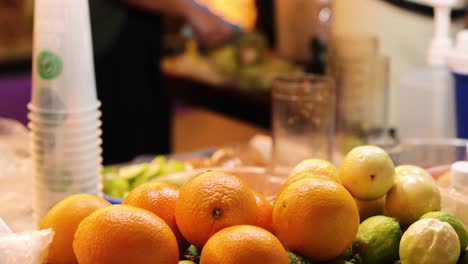 Fresh oranges and limes at a market stall
