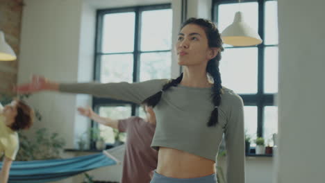 asian woman doing side stretch on yoga class