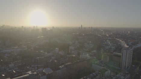 brightly shining sun over the horizon hitting the rooftops and buildings of knightsbridge district in west london