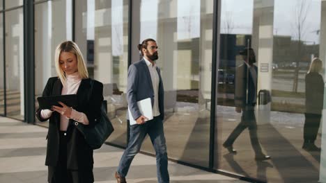 business people outside in front of the office building