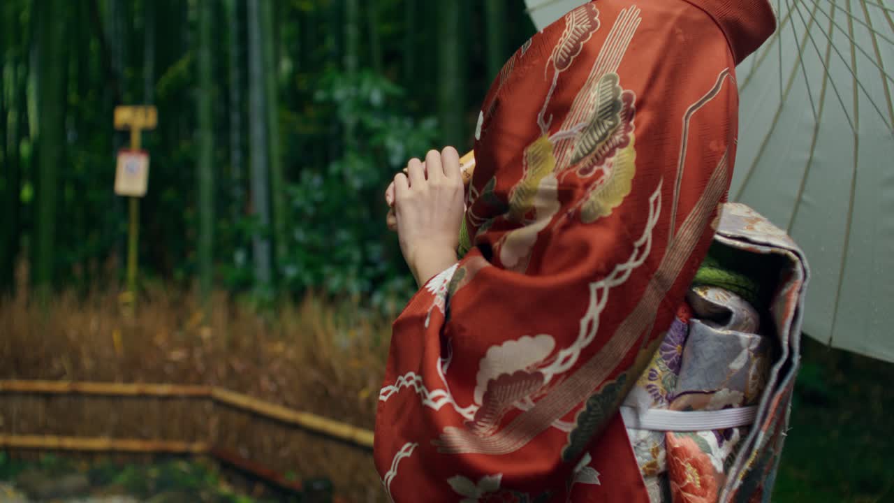Woman in Kimono in a Bamboo Forest on a Rainy Day