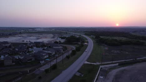 Flying-into-the-sunset-over-developing-neighborhoods