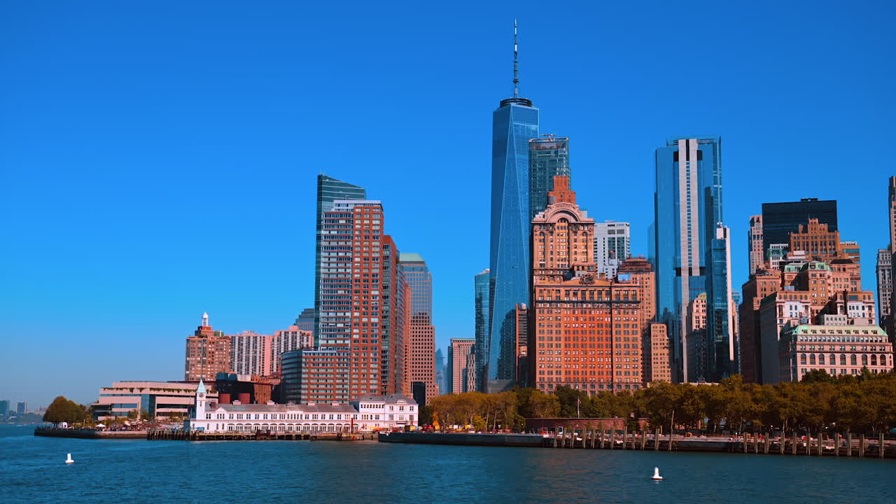 Gorgeous New York skyscrapers and high-rises against blue clear sky. Big Apple skyline from the East River waterscape