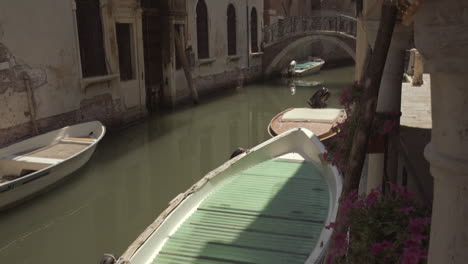 boats parked in venice canal on a sunny day, italy