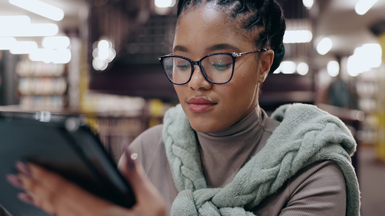 Woman Using Tablet in Library