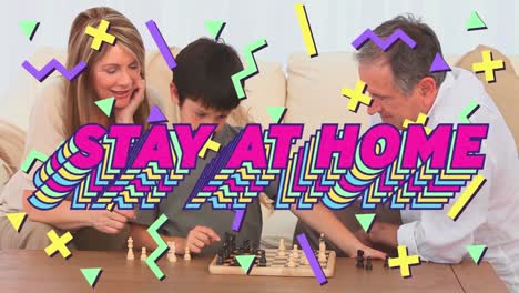 Animation-of-colourful-words-Stay-At-Home-over-Caucasian-family-playing-chess