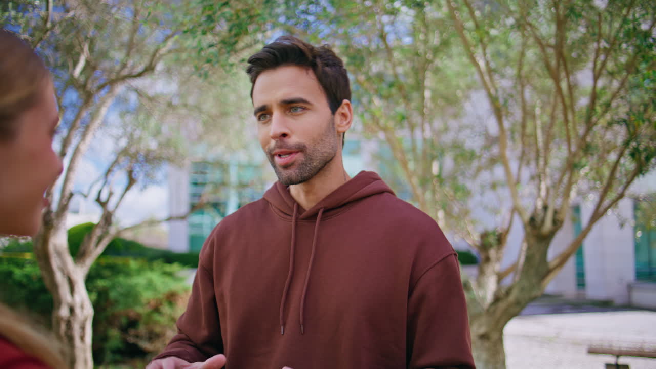 Smiling athletes giving high five. Closeup handsome fitness coach talking woman