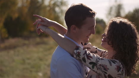 smiling lovers in golden meadow