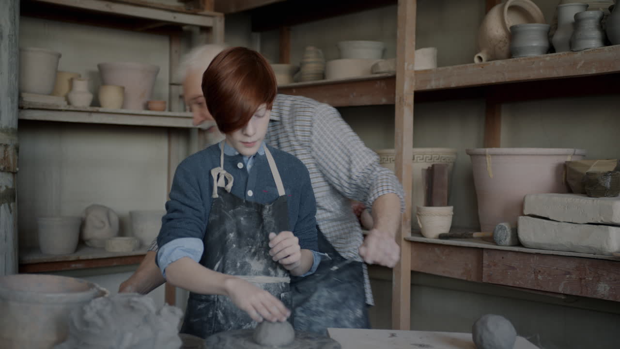 Teenager and Senior Learning Pottery