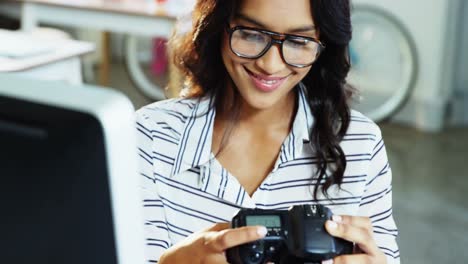 Female-business-executive-looking-at-digital-camera