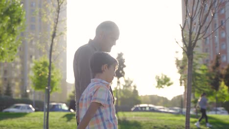 The-grandfather-is-walking-and-walking-outside-with-his-grandson.