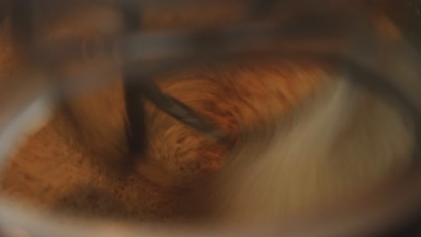 close-up shot of a fast-spinning mixer mixing scone ingredients in a metal bowl