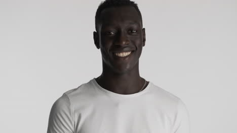 happy african american man on grey background.