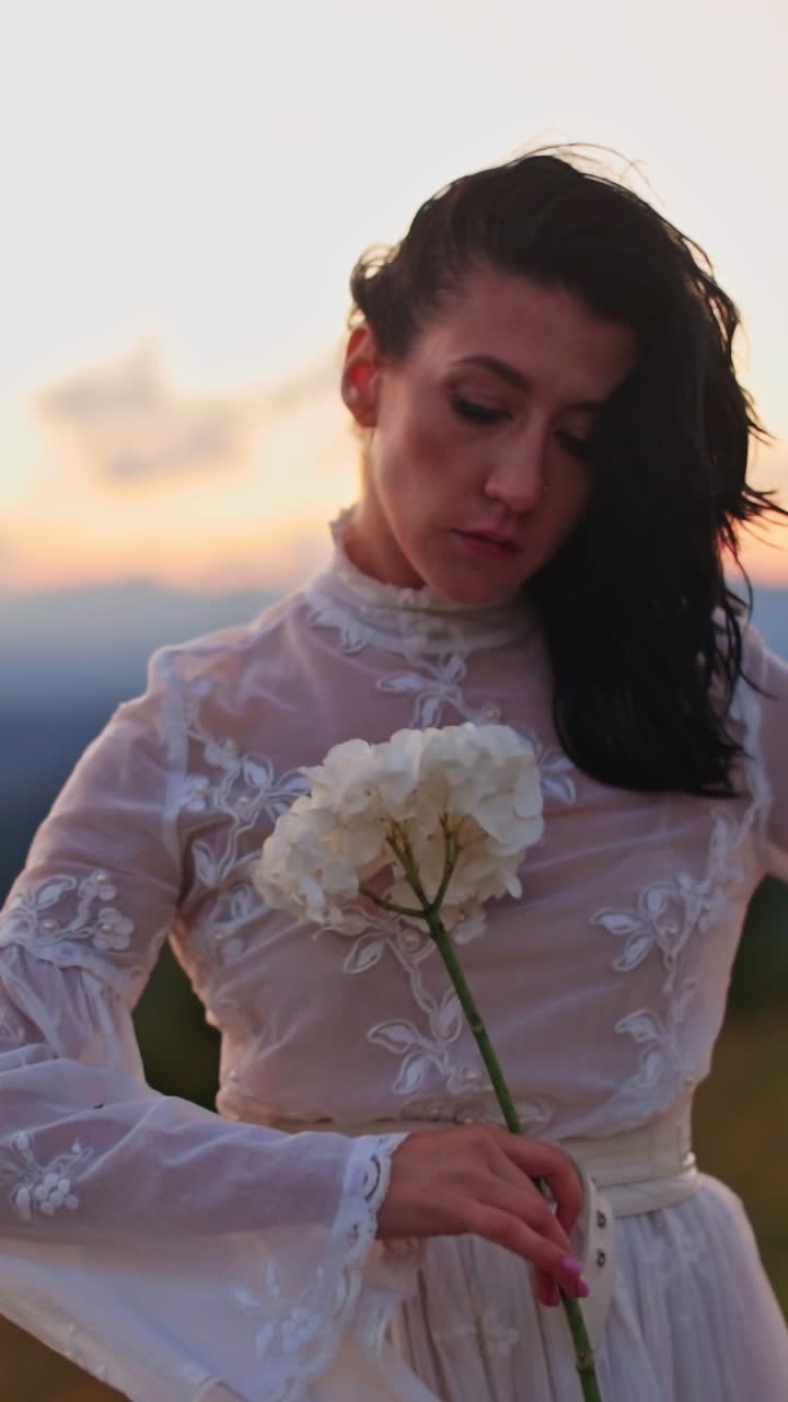 Beautiful lady in dress dancing on nature. Cheerful pretty woman walking on beautiful landscapes. Vertical video