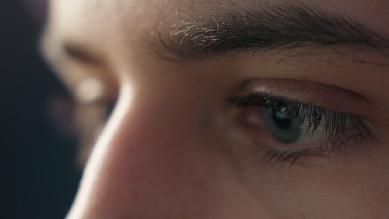 Closeup shot of a boy's eye while working on his computer