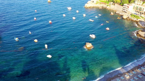 Bird's-eye-view-of-the-beautiful-Sicilian-beach-and-Mediterranean-Sea-filled-with-tiny-ships