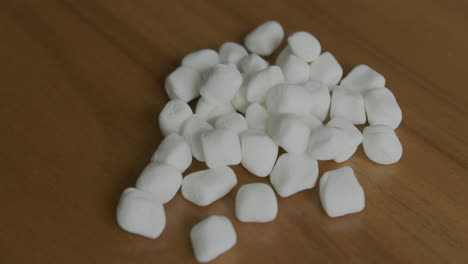 close up tilt up of a pile of mini marshmallows